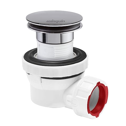 Kit bonde à dôme chromé et siphon compact installé sous un lavabo en céramique ivoire