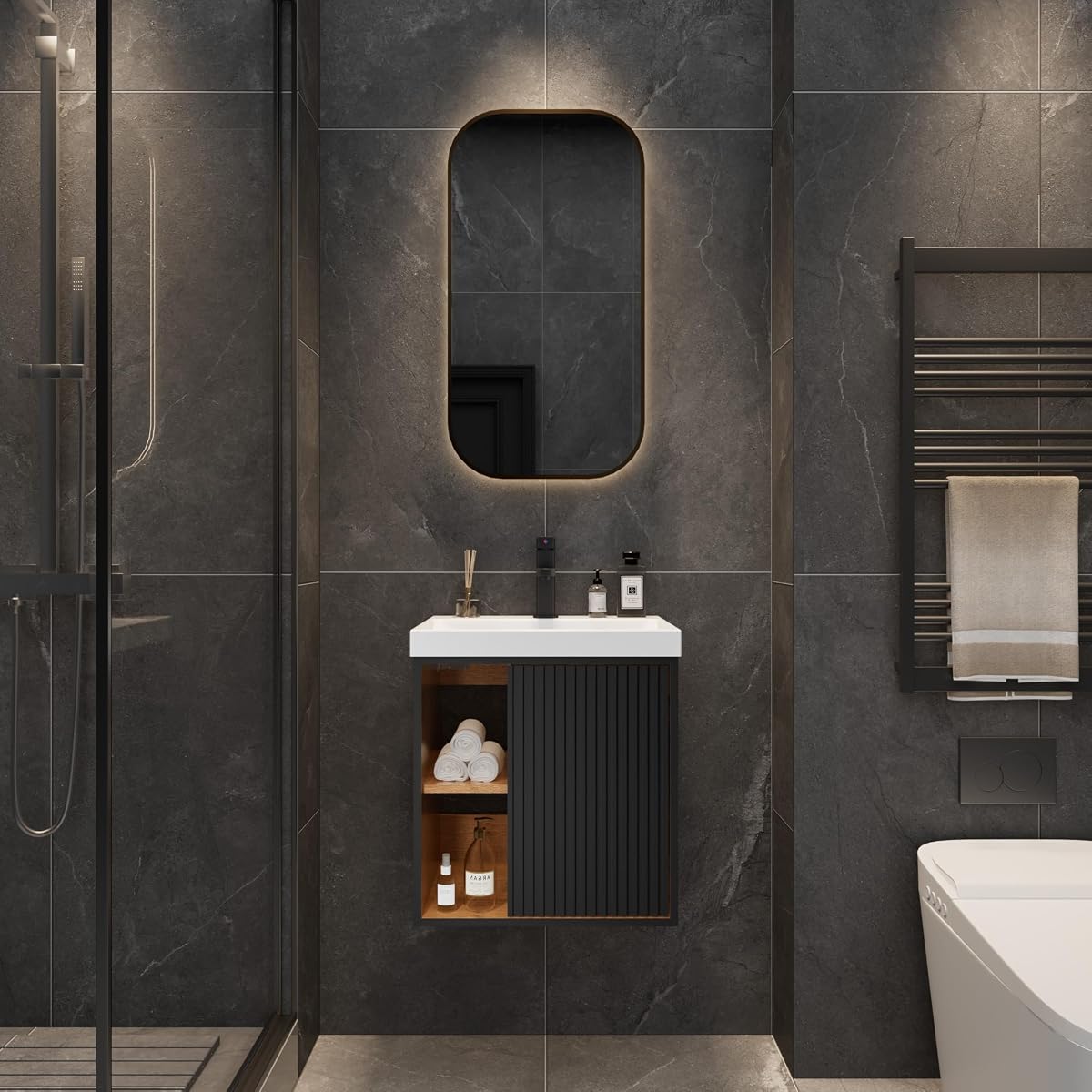Meuble lave-mains noir suspendu à façade cannelée, avec lavabo en résine et rangement à deux portes.